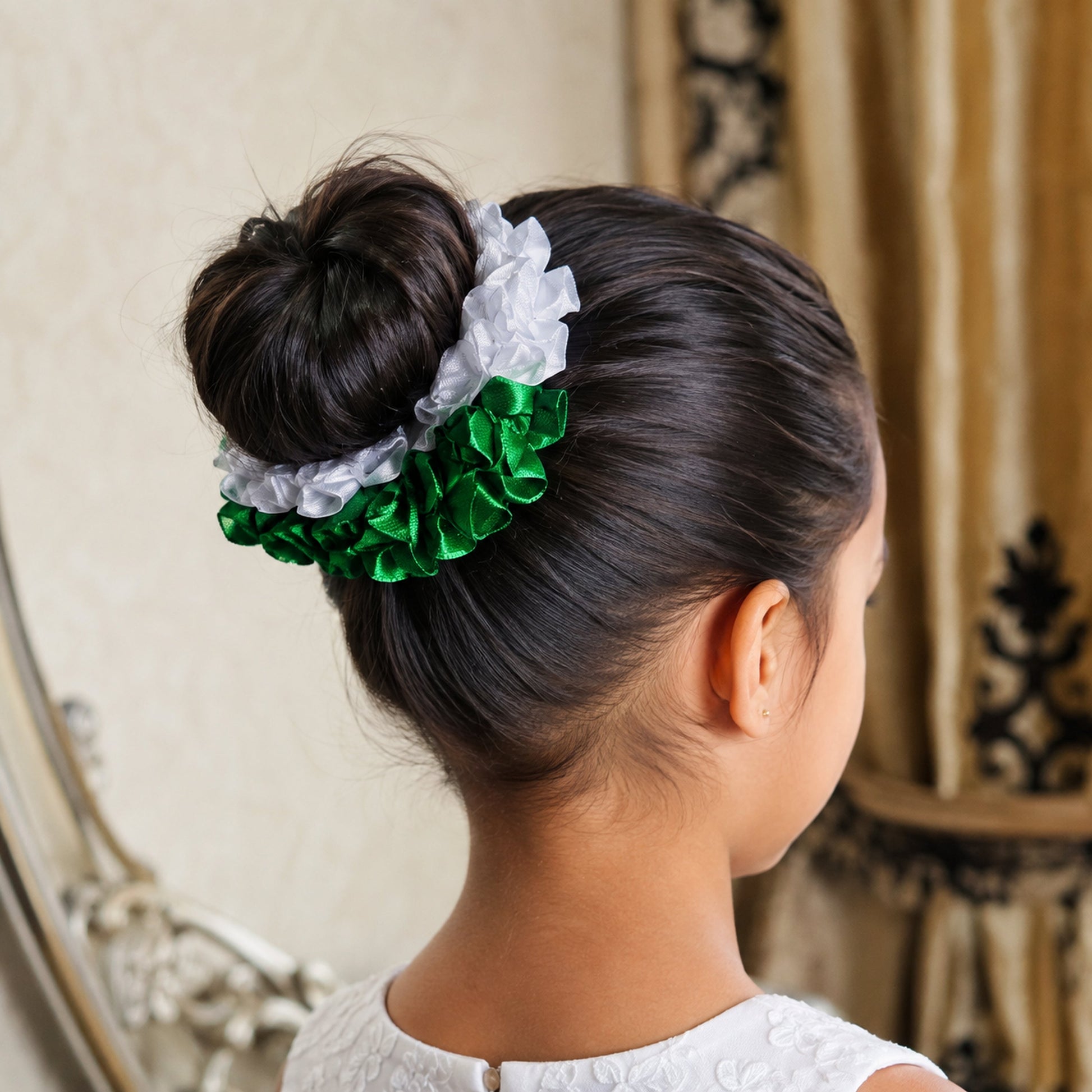 Fictional child wearing the Azadi green and white floral gajra around a neat hair bun