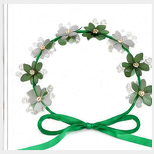 Azadi green and white floral hair crown with clear bead accents on a clean neutral background
