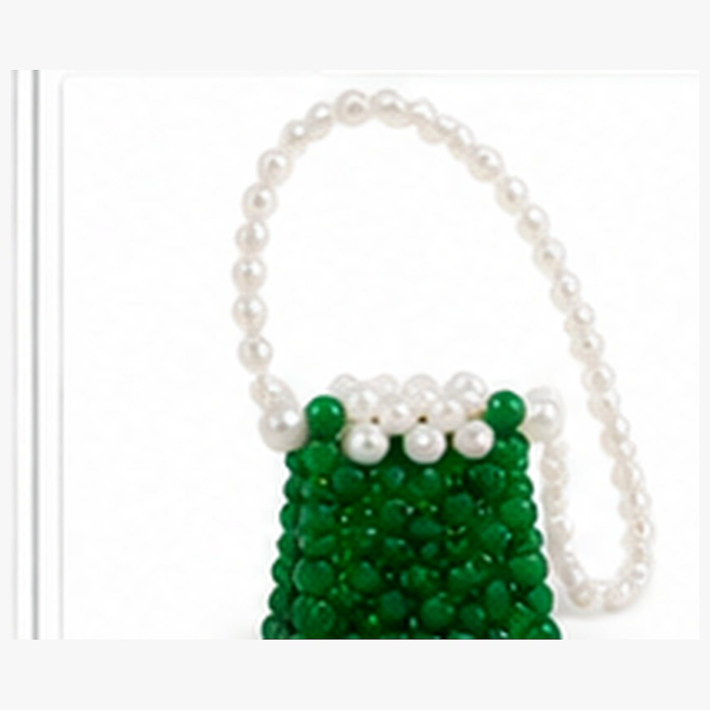 Green and white mini beaded purse with pearl-look handle and long matching strap on a clean white background