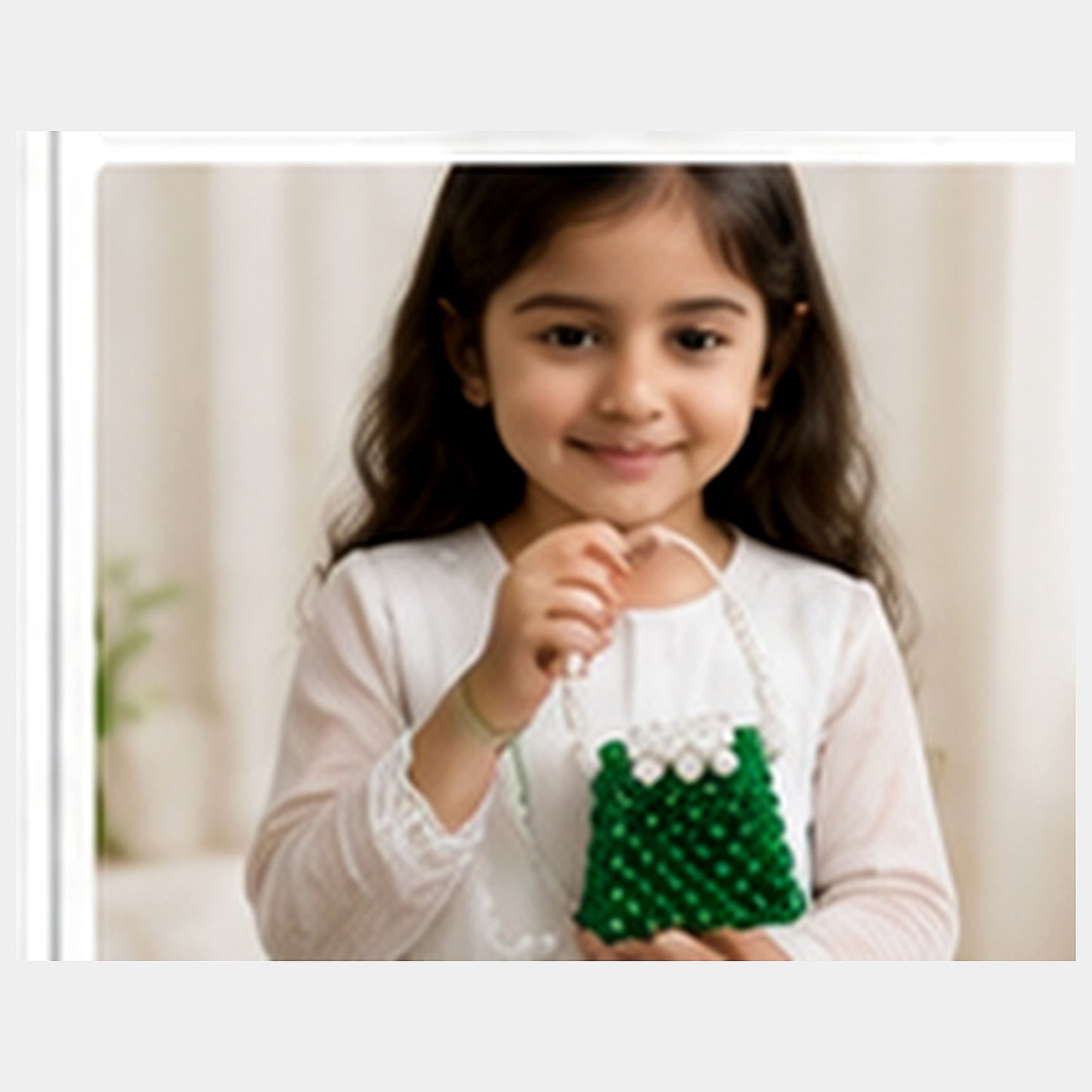 Fictional child carrying the green and white mini beaded purse with its pearl-look strap
