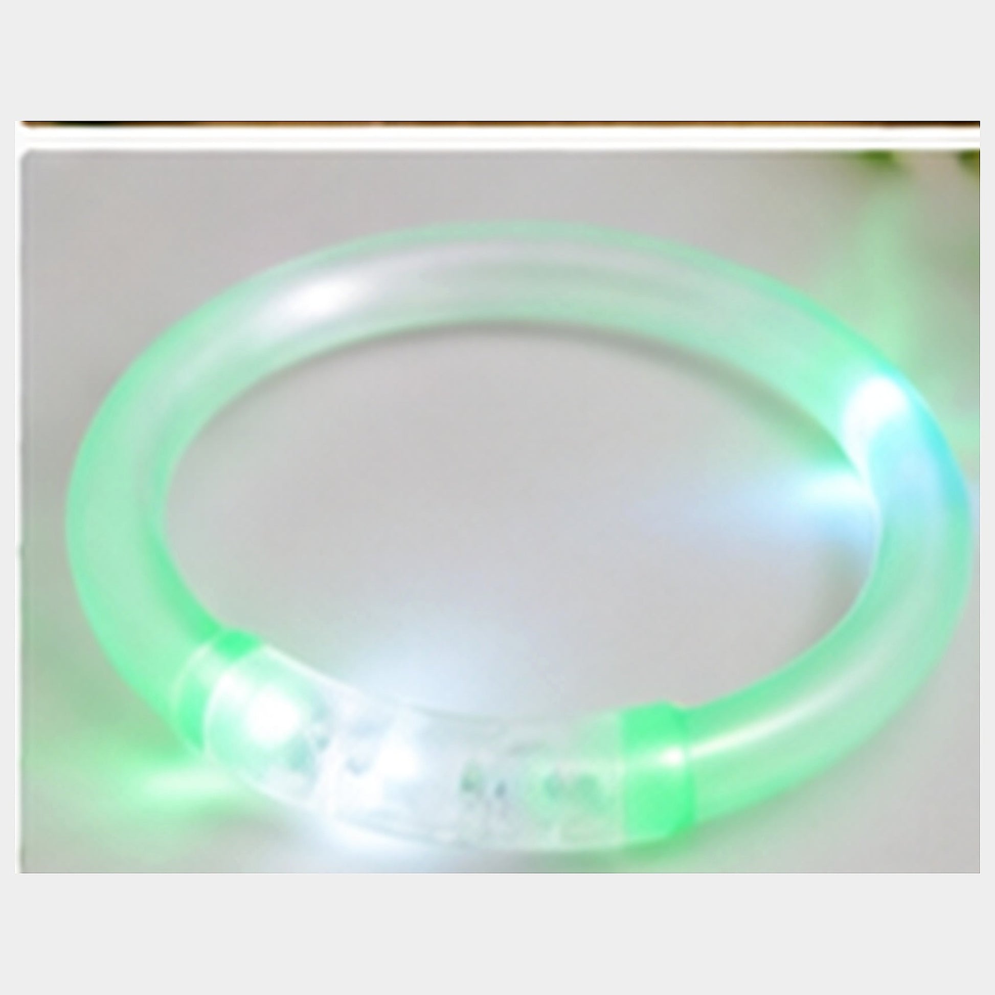 Macro close-up of the translucent green bracelet tube, glow and clear connecting section