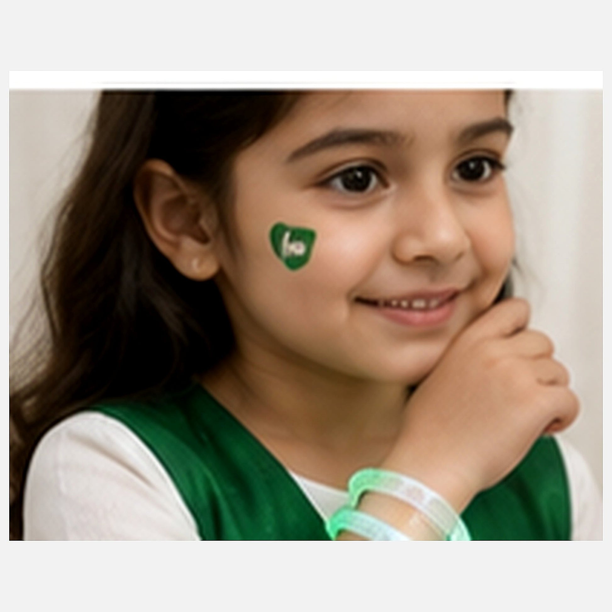 Fictional child wearing one glowing green Pakistan LED bracelet on the wrist